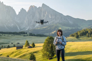 DJI Mini 5 Pro flying near a hiker in a mountain valley