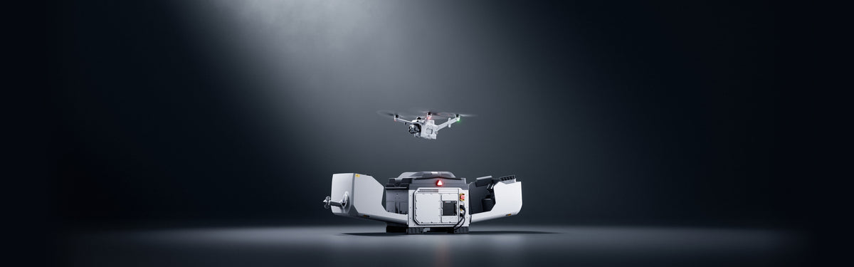DJI Dock 4 with Matrice 5TD hovering above the open dock against a dark background