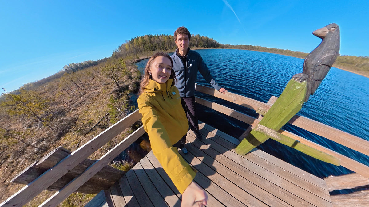 DJI Osmo 360 II wide-angle sample of two people taking a selfie on a lakeside wooden platform