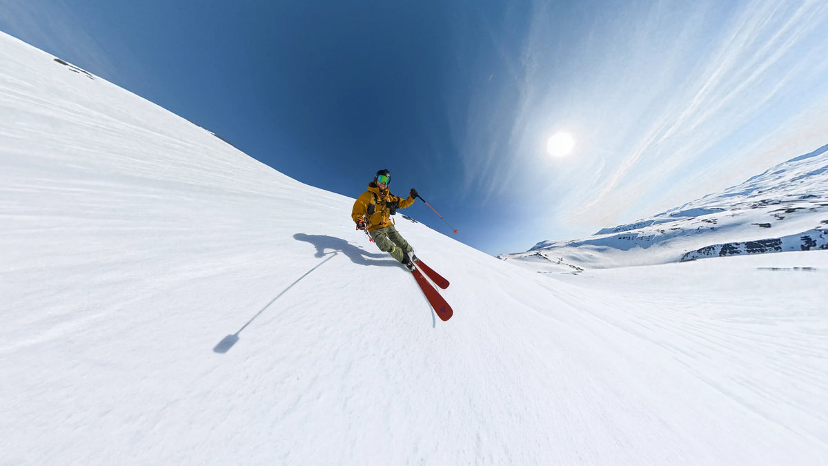DJI Osmo 360 II sample of a skier descending a snowy mountain under a blue sky